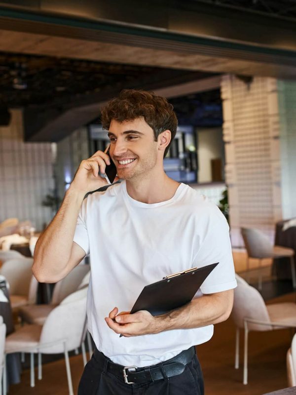 smiling-event-organizer-with-clipboard-talking-on-smartphone-near-festive-tables-in-banquet-hall.jpg smiling-event-organizer-with-clipboard-talking-on-smartphone-near-festive-tables-in-banquet-hall.jpg
